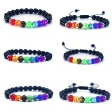 Detail of 7 chakra natural stone bead bracelets with matte black beads and elastic cord