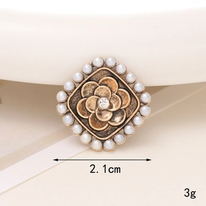 Macro shot of vintage style 2.1cm square bronze charm with pearls and crystal inlay