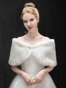 Detailed view of white faux fur bridal shawl with a luxury sparkling rhinestone brooch