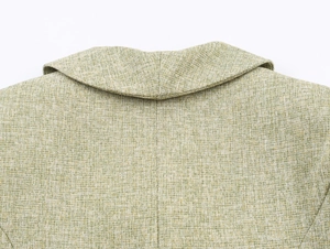 Macro detail of the light green tweed jacket collar showing premium woven fabric texture