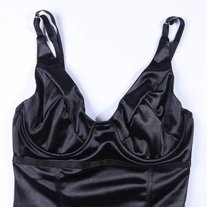 Detail of black satin bodysuit featuring adjustable spaghetti straps and silk texture