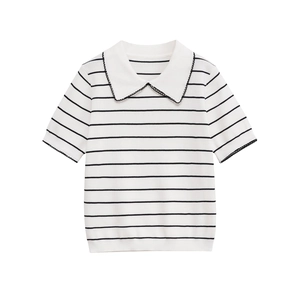 White knit polo shirt with black stripes and elegant lace collar detail on plain background