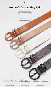Detail view of five assorted cowhide leather belts with round alloy pin buckles