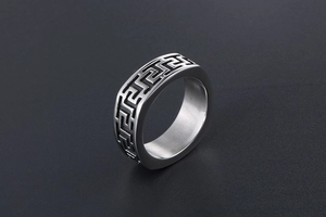 Macro shot of titanium steel ring with vintage Great Wall meander pattern engraving