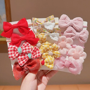 Kids elastic hair bands set with cute bows and floral clips on a white display card