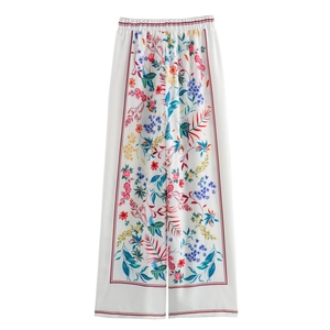 Women's resort style floral wide leg pants in white with colorful pattern print
