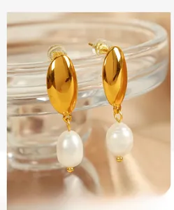 Detail of 18K gold plated crescent moon earrings with natural freshwater pearl pendants