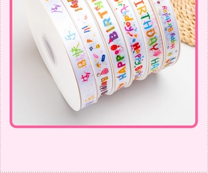 Detail of colorful Happy Birthday printed ribbons in red and pink for gift wrapping