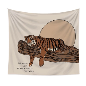 Bohemian tapestry featuring a resting tiger illustration and motivational text on beige fabric