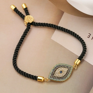 Detail of evil eye bracelet with blue zircons and black rope for women and girls