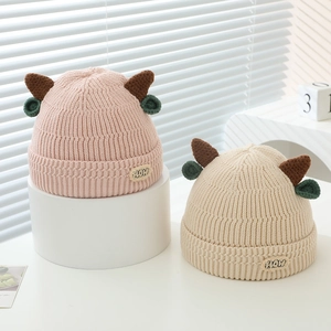 Cute knit beanie for toddlers with horns and HOW patch in pink and beige colors