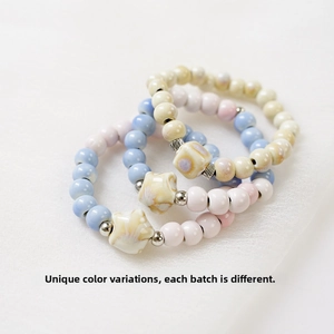 Detailed view of handmade ceramic beaded bracelets with unique kiln-fired glaze effects