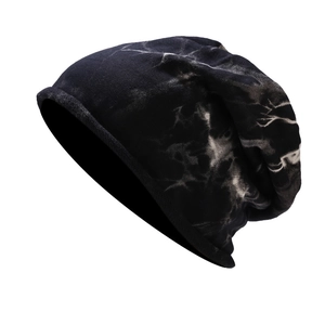 Side view of a soft knit beanie featuring a black and white tie-dye marble texture