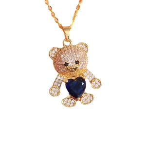 Exquisite gold bear necklace with white cubic zirconia and a deep blue heart gemstone
