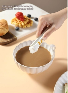 Miniature cat paw food tongs picking up sugar cubes for coffee at afternoon tea