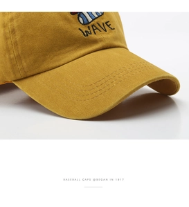 Detail of embroidered WAVE logo on washed cotton baseball cap with premium stitching