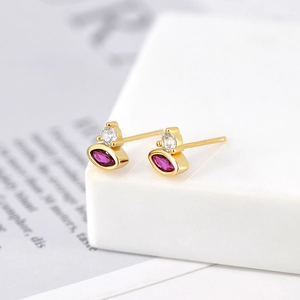 Macro shot of marquise rose-red stones and zircons on gold-plated s925 silver earrings