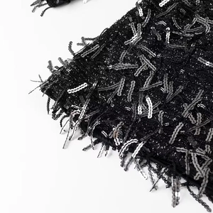 Fashionable black mini dress featuring shimmering sequins and elegant fringe details