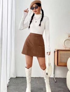 Detail of high-waist brown PU leather A-line mini skirt with stylish side stitching