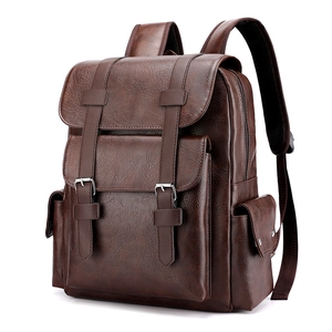 Brown vintage PU leather backpack with buckle straps and multiple pockets on white background
