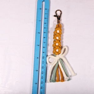 Bohemian handmade woven daisy flower keychain with yellow petals and fringe tassel detail
