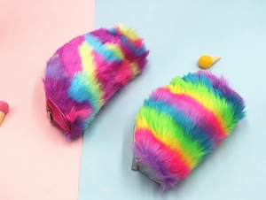 Detailed close-up of two fuzzy rainbow faux fur pencil cases with soft plush texture