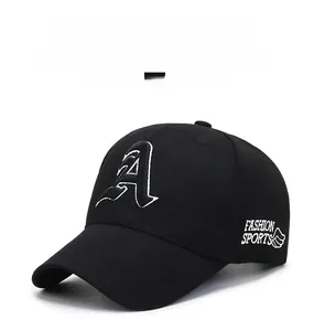 Close-up of white 3D letter A embroidery and side wing logo on black cotton baseball cap