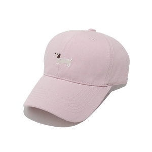 Close-up of pink cotton baseball cap with detailed dachshund dog embroidery and curved brim