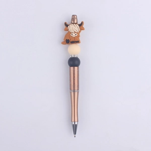 Detail of DIY beaded pen featuring a cute bronze glitter body and highland cow bead