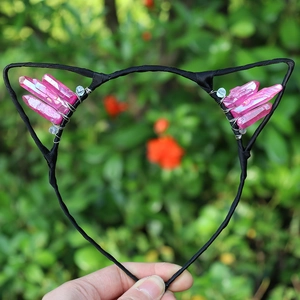 Close-up of handmade cat ear headband with pink crystals and blue beads for party hair