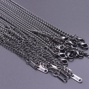 Detail of 2.5mm black stainless steel keel chains featuring lobster clasps and steel tags