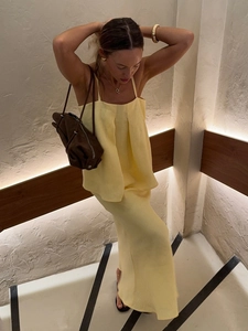 Detailed texture of pale yellow cotton linen set with pleated top and long skirt