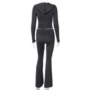 Back view of black long sleeve cropped hoodie and high waist flared pants set
