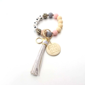 Detail of MAMA beaded wristlet keychain with silicone beads and leopard print wood