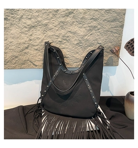 Detail view of Bohemian black fringe tote with sun embroidery and silver stud rivets