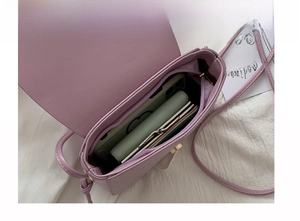 Internal view of purple crossbody bag showing space for smartphone and wallet