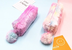 Detail of soft rainbow plush pencil case featuring a fluffy pompom zipper and fuzzy texture
