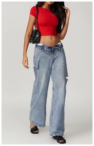 Close-up of a red slim-fit cropped sports T-shirt paired with blue distressed denim jeans