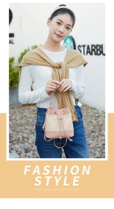 Detail of pink leather and beige straw bucket bag with drawstring and metal ring