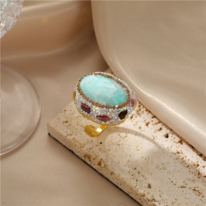 Close-up of a Baroque style gold ring with turquoise stone and colorful gemstones