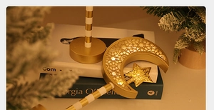 Close-up of golden moon and star LED light with hollow geometric patterns