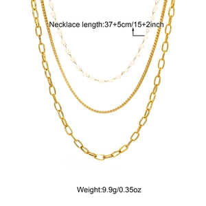 Detail view of 18K gold plated triple layered necklace with white pearls and varied chains