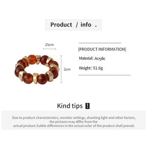 Detail of amber acrylic beaded bracelet featuring gold metal spacers and 51.6g weight