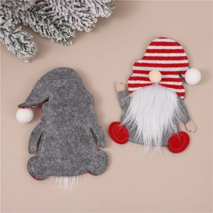Macro view of Christmas gnome cutlery holder with red striped hat and felt beard detail
