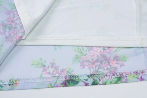 Detail of floral mesh fabric showing precise hem stitching and double-layered structure
