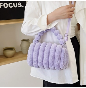 Detailed view of a purple plush handbag with unique segmented textured faux fur design