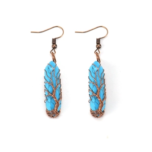 Detail of tree of life wire-wrapped long drop earrings with blue stone pendants