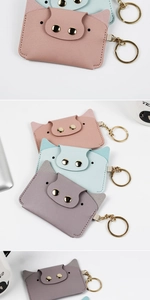 Close-up of pink, blue, and purple PU leather cartoon pig card holders with keyrings