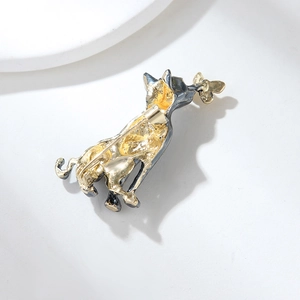 Detailed back view of a cartoon cat brooch showing the secure metal pin fastening mechanism