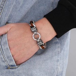 Detail view of men's tiger head bracelet with braided cord and silver metal clasp